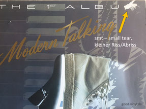 Rechts oben am Cover-Rand ein kleiner Abriss am Album "Modern Talking - The 1st Album" (GER 1985)