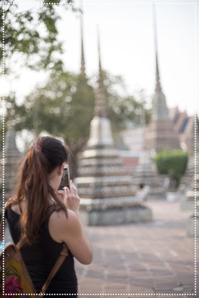 Irene taking pictures with her phone in Bangkok