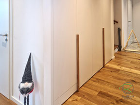 Wandbündiges Flurmöbel in Spaichingen von Schreinerei Holzdesign Ralf Rapp in weiß und Eiche Griffleisten unten Frontbündige elektrische Klappe für Staubsauger-Roboter-Garage