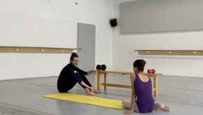trainer explaining work to ballet student