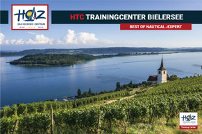Blick über Rebberge bei Ligerz auf den Bielersee mit St.-Peters-Kirche und St.-Petersinsel – Standort HOZ HTC Trainingcenter Bielersee