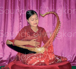 Burmese harpist playing on silk strings.