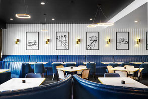 Restaurant interior design at The Delany Hotel, Newcastle – layered lighting, warm tones, and structured dining layout by Flourish Interior Design.