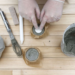 Setting candles in concrete as part of the DIY Concrete Candle Holder Tutorial, a wonderfully easy concrete diy with recycled moulds and baking paper to create a tree bark texture! #diy #concrete #tutorial #pasinga #blogging