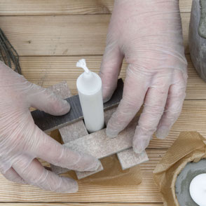 Setting a dinner candle into concrete as part of the DIY Concrete Candle Holder Tutorial! #diy #concrete #crafting #tutorial #pasinga #blogging