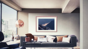 Photo of a living room with a fine art print of Lake Como and a flying crow seen from the Grigna