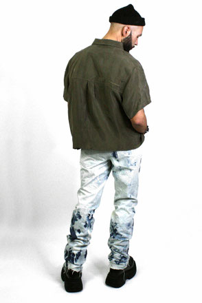 model with denim washed jeans and olive shirt 