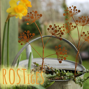 Gartenstecker in Form eines Vogels in Rostoptik in eine Minze-Pflanze gesteckt. Bild hat eine orangene Aufschrift "Rostiges". 