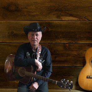 Roger Hamelin holding his guitar