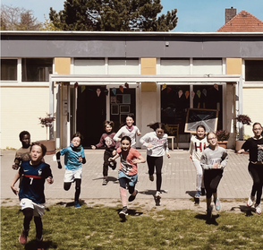 Kinder rennen aus dem Gebäude.