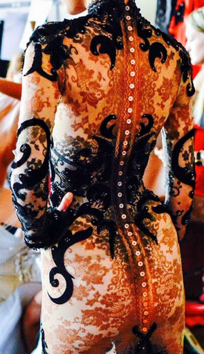 Tatooed body in Calais' lace and black velvet. 15th Anniversary Couture show backstage - Palais Brongniart, Paris 2015