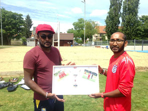 Sahan (l) receives a birthday gift from WCC captain (r)