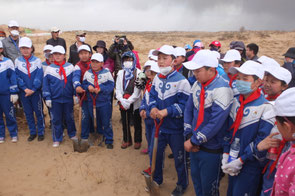 Prior to tree planting, receiving a lecture on the significance of the activities and how to handle seedlings