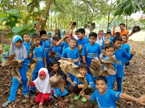 Children collection collect fallen leaves which are used for composting