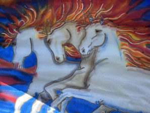 three white horses on a dramatic background