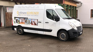 Weißer Transporter der Großmann Schreinerei vor Werkstattgebäude geparkt