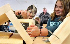 5th-graders Kaleb Lawrence, left, and Riley Leining partner up on the construction of their bee houses. The bee houses were bulit under the guidance of Michael Nerrie, chief environmental observer of Distant Hill Gardens in Walpole.