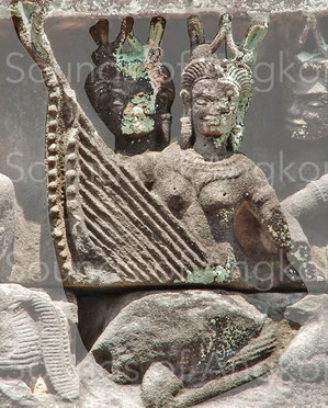 You see here two harps represented one behind the other. The one at the back shows 15 tuning pegs and some are broken. Banteay Samre.