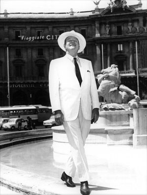 John Wayne during production of "Cast a Giant Shadow" in Rome, vistiting the Trevi Fountain.