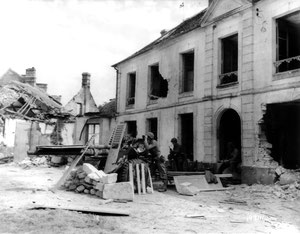 Place de l'arbre de la Liberté. An M5 gun of 607 TD is pointing towards Chambois, 15 or 16 August 1944. The crew consisting of Pfc William J. Pierson and Cpl John J.Blair of C Coy. Third one unidentified (not on dutyroster). Shutters provide some camo.