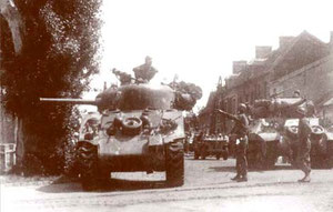 A Sherman M4 tank having its turret turned towards Chambois, the MP directing that way too. Chambois has still to be liberated!