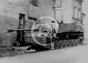 StuG, pinned down on Rue des Polonais. Two inhabitants pose in front of the giant lump of steel.