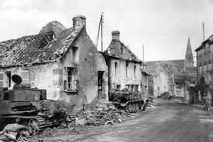 A PzKpfW IV beneath a house on the left and an SdKfZ 9 alongside the road towards Chambois, both relics of the combat for Fel and Chambois.