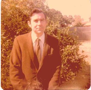 Jim Fanning in the backyard in front of the orange tree