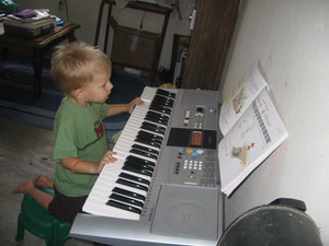 Caleb experimenting with our new keyboard that we use for music lessons.