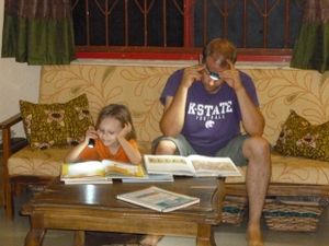 Eric & Naomi reading together by flashlight