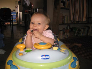 Naomi likes her baby walker. She doesn't talk much, but she will bark at the dogs.