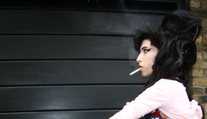 Amy Winehouse smoking a cigerette outside her home Camden UK