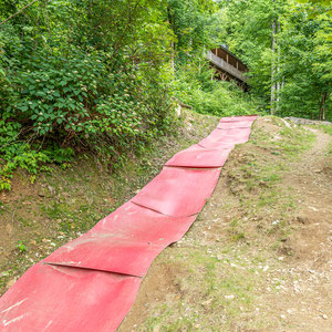 Hillside slide starts next to the campfire area. Burlap sacks are provided to slide on.