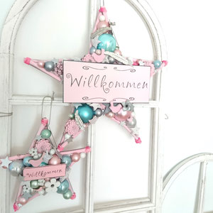 Zwei Sterne mit rosa Willkommenschildern und in pastelligen Farbtönen gearbeitet.