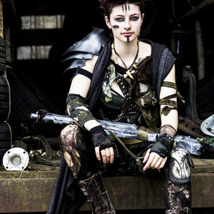Heavily distressed post-apocalyptic costume and prop made with recycled materials.
