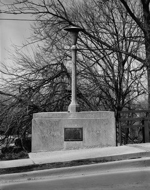 Benton Street Bridge in Iowa City: Northwest abutment, showing an original light fixture and the 'historical tablet,' looking north-northeast 