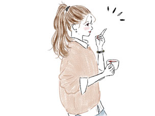 コーヒーを飲みながらアイデアが浮かんだセーターにポニーテール姿の女性。