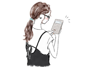 電卓をたたく眼鏡をかけた女性。