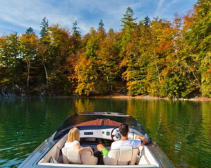 Bootsfahrt auf dem Wolfgangsee mit herbstlicher Uferlandschaft und kristallklarem Wasser im Salzkammergut