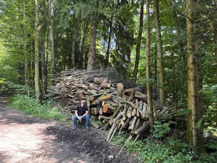 Foto von Mann vor Holzsstapel
