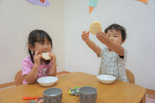 保育園で手作りのおやつを食べる子ども達