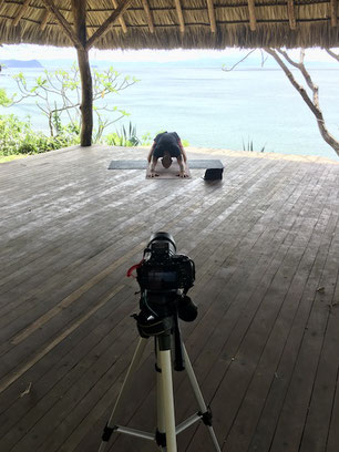 yoga teacher shooting a video in outdoor yoga shala with sea view in Nicaragua