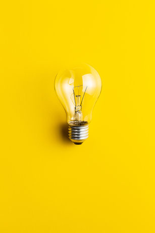 An image of a lightbulb on a yellow background