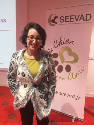 La chargée de mission de Canidea devant le kakémono du séminaire "le chien mon ami"