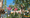 Family climbing at the CLIMB UP! high ropes course – family secured on a beam obstacle, waving