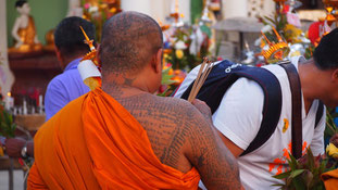 Monk covered in prayers