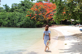 Woman walking along white sand beach in hidden lagoon - Day Trip to Negril