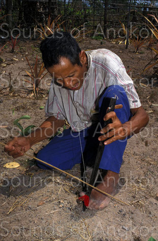 B. Player of buccal resonator fiddle. Bahnar. Vietnam.