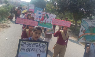 Students holding hand-written placards and posters appealed the community for environmental conservation