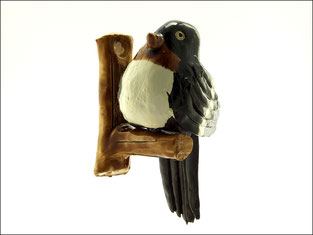 Oiseau sur perchoir en céramique